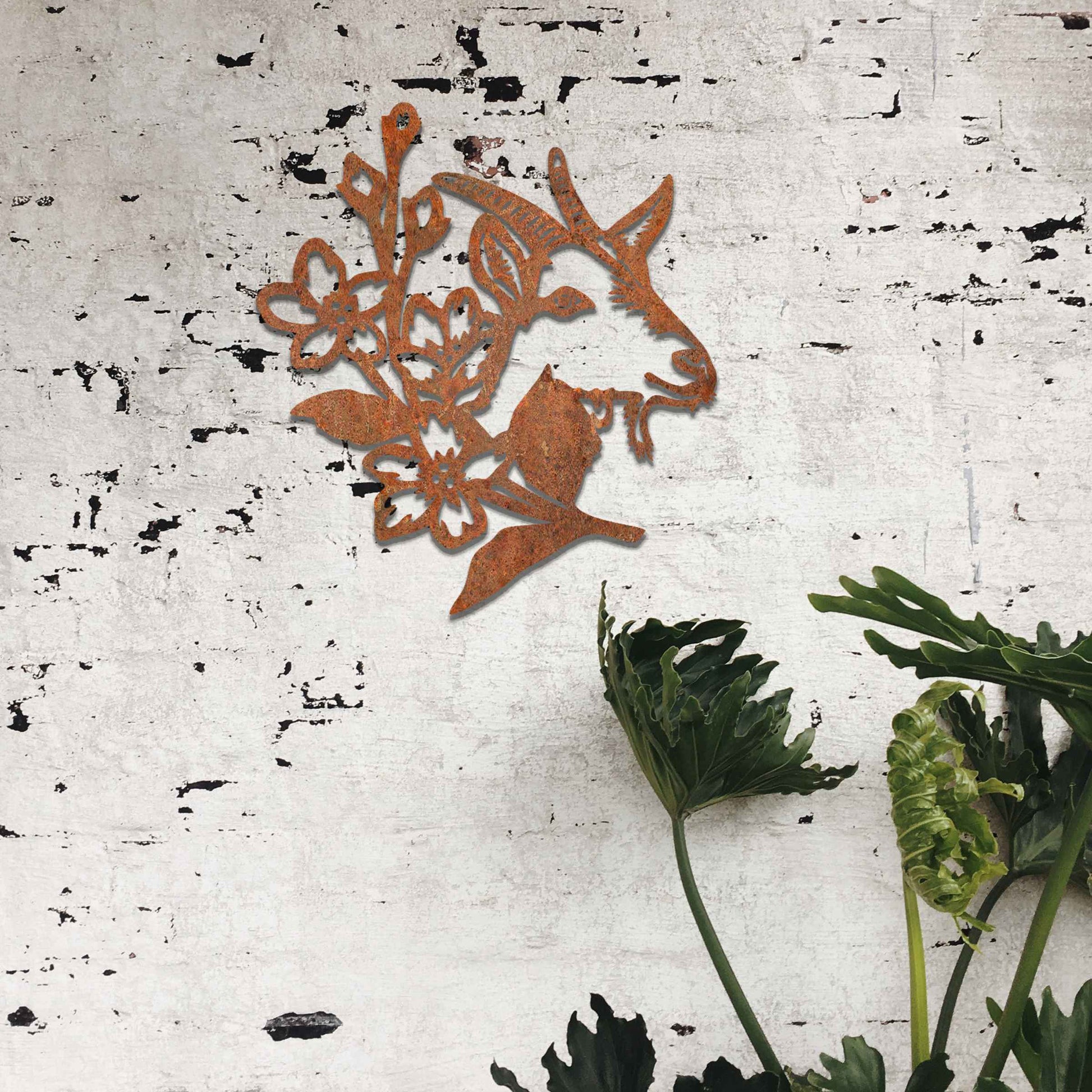 Goat head silhouette with delicate floral details integrated into the design. The artwork captures the goat’s profile surrounded by blooming flowers, creating a rustic, natural aesthetic for modern wall decor.