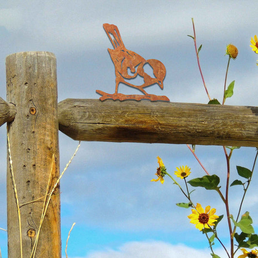 Metal garden decoration featuring a bird silhouette with a rustic finish, perched on a branch, designed to enhance fence tops or wooden posts, adding a natural and charming touch to outdoor spaces.