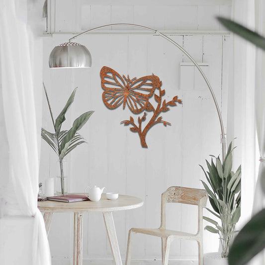 Metal garden decoration featuring a butterfly resting on a leafy branch, crafted with intricate detailing to bring a touch of nature-inspired elegance and charm to outdoor walls or garden settings.