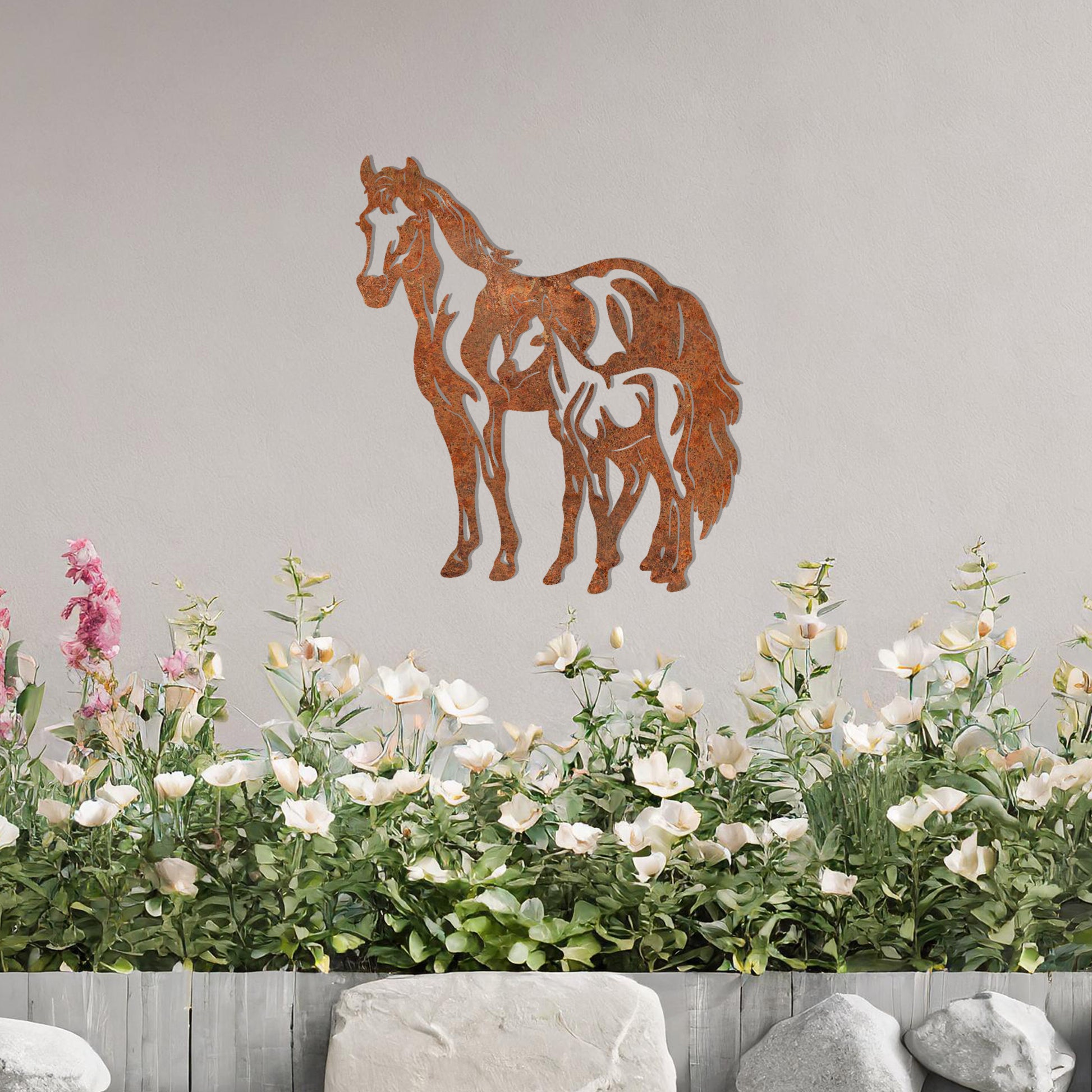 A stunning metal wall art design featuring two horses, showcasing a larger horse and a smaller one standing together, symbolising grace and unity. This artwork adds an elegant touch to a neutral wall in a beautifully styled outdoor space.