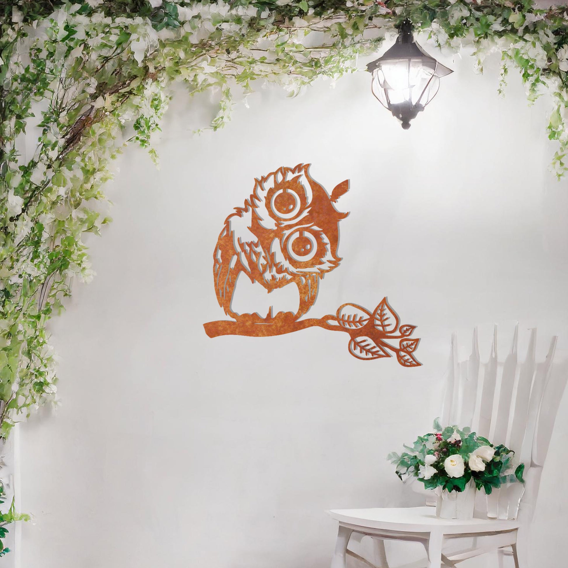 A delightful metal wall art design featuring a whimsical owl perched on a branch with intricate detailing of its feathers and expressive eyes, adding a playful and nature-inspired touch to any setting.