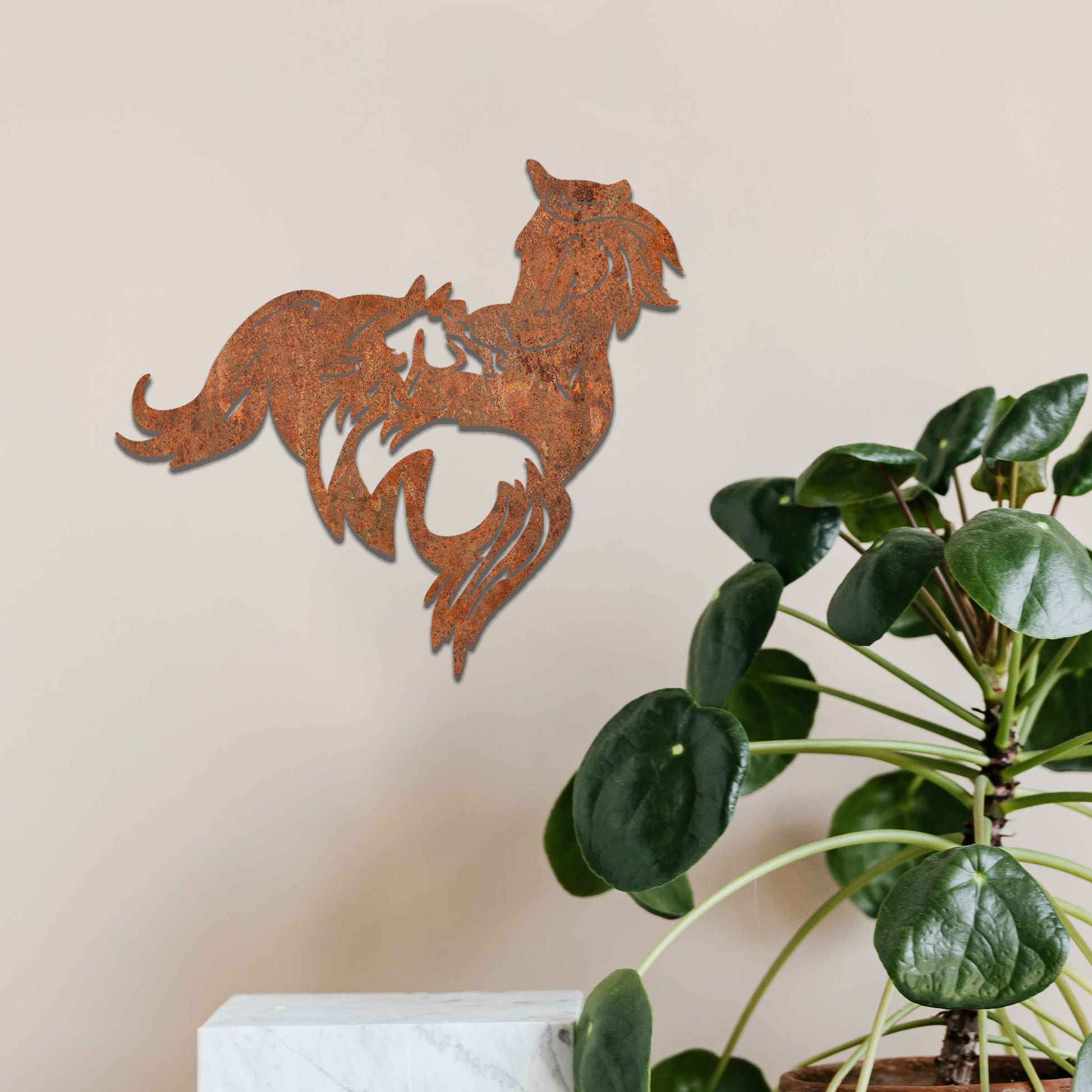 Metal wall decoration featuring a large horse with a smaller horse standing beside it, crafted with intricate cutout details and a rustic finish, adding a graceful and heartwarming touch to indoor or outdoor spaces.