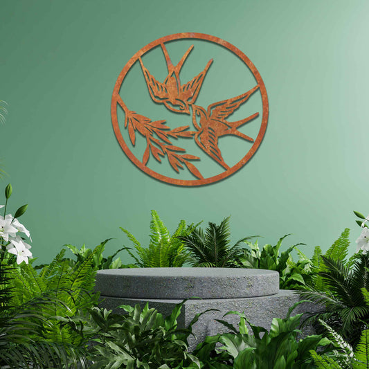 Metal garden decoration featuring two swallows in flight within a circular frame, accented by delicate branch details, combining nature-inspired elegance and craftsmanship to enhance outdoor or indoor spaces.
