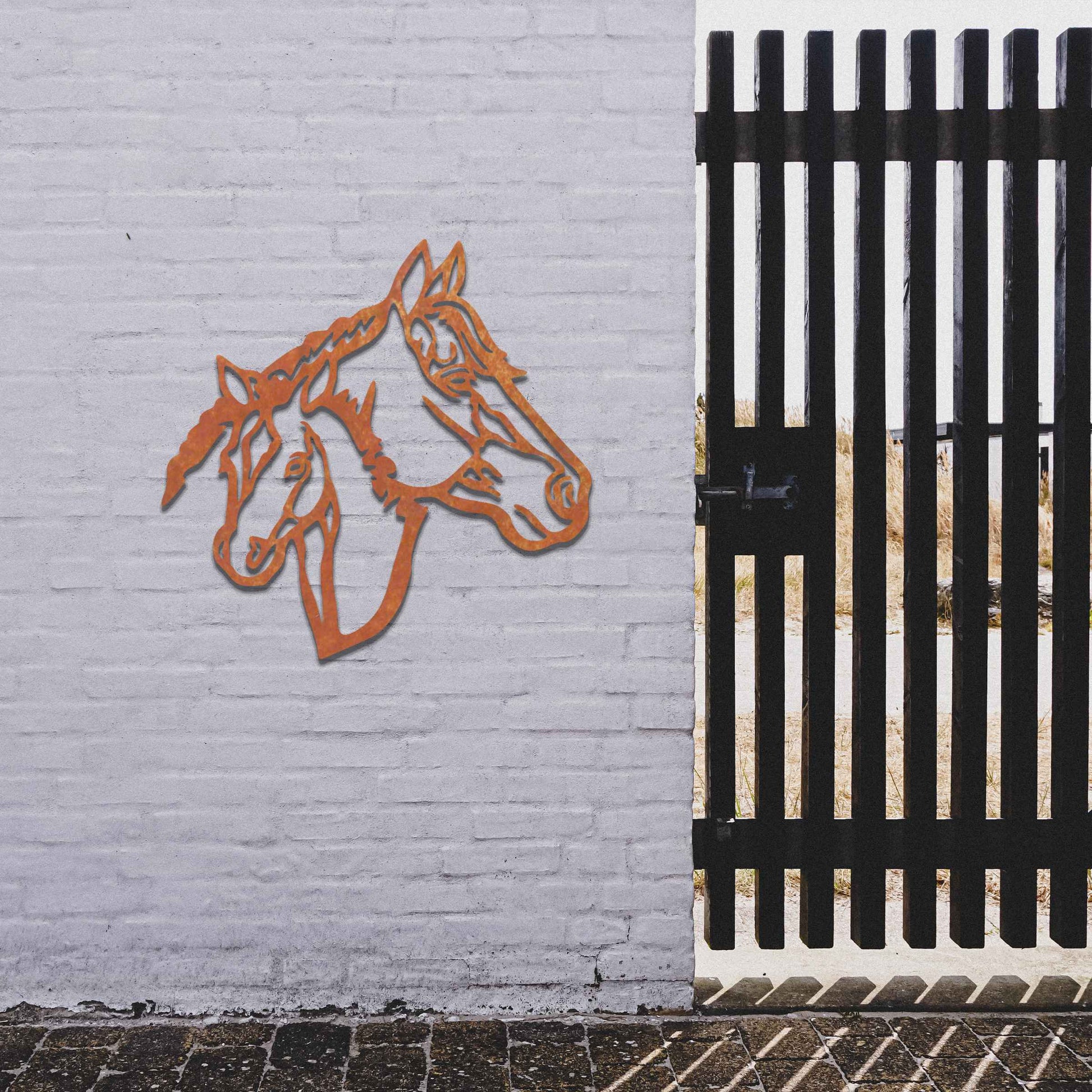 Metal wall art featuring the heads of two horses, one adult and one foal, side by side. The artwork is designed with bold, clean lines, emphasizing the intricate details of the horses' faces.