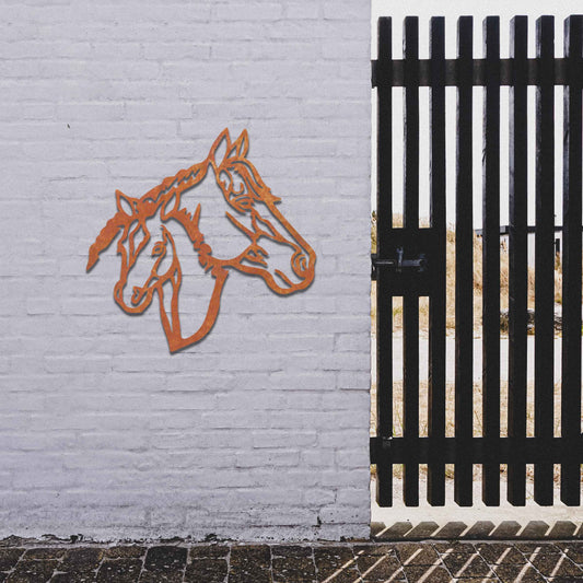 Metal wall art featuring the heads of two horses, one adult and one foal, side by side. The artwork is designed with bold, clean lines, emphasizing the intricate details of the horses' faces.