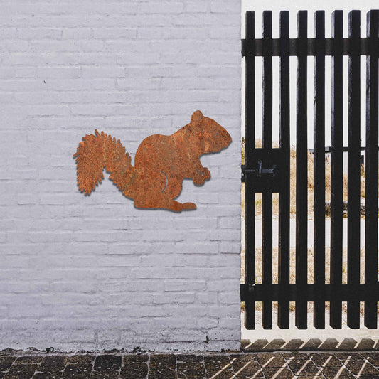 Metal garden decoration featuring a squirrel silhouette with a textured design, adding a rustic and playful accent to outdoor walls, complementing natural and minimalist garden aesthetics.