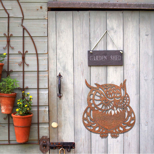 Metal garden decoration featuring a detailed owl design with intricate patterns, adding a touch of nocturnal charm and artistry to outdoor walls, enhancing the beauty of any garden or patio setting.