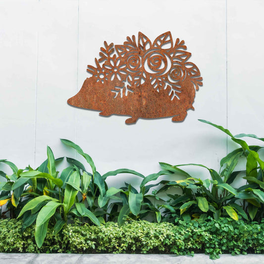 Metal garden decoration featuring a hedgehog-shaped design with intricate floral cutouts, adding a charming and rustic touch to outdoor spaces, perfectly blending with garden greenery.