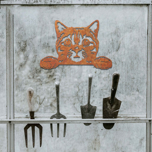 A charming metal wall art piece featuring an adorable cat peeking over a surface, its wide eyes and paws reaching out, adding a playful and endearing touch to modern home decor.