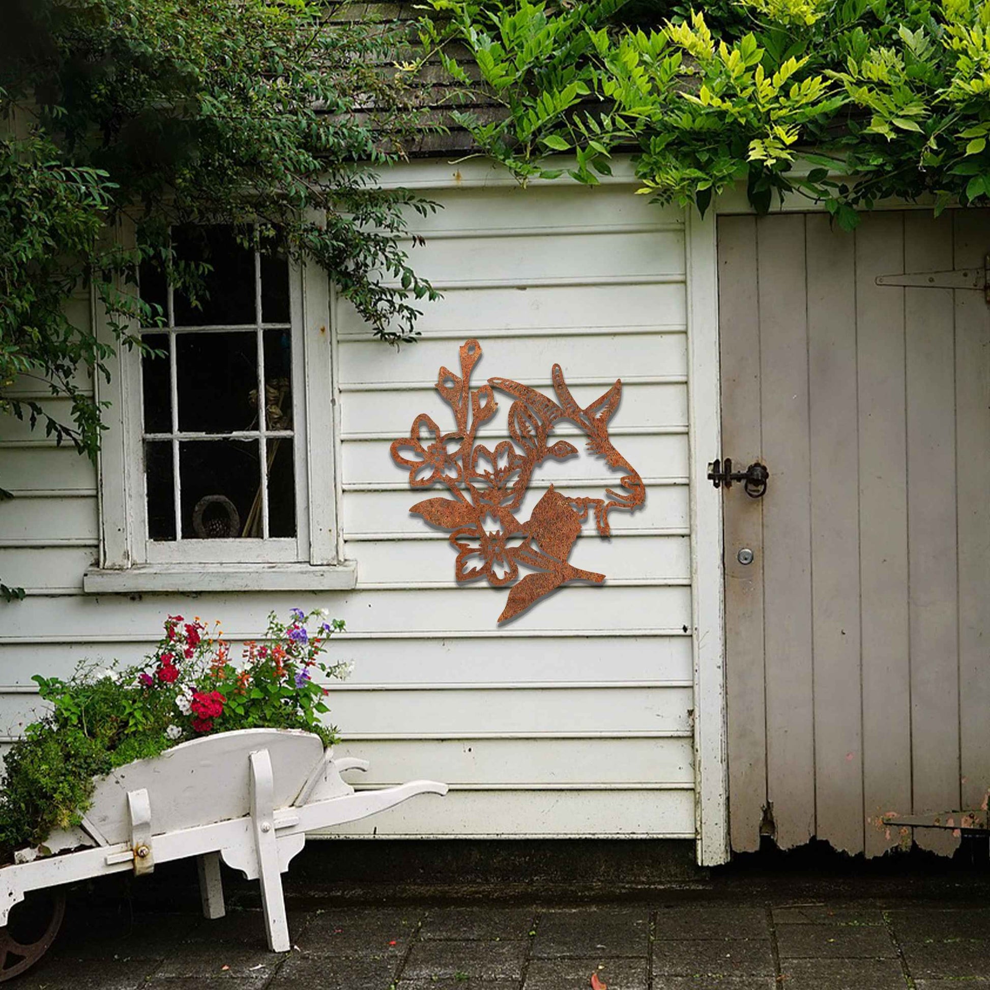 Goat head silhouette with delicate floral details integrated into the design. The artwork captures the goat’s profile surrounded by blooming flowers, creating a rustic, natural aesthetic for modern wall decor.