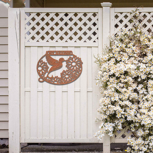Metal garden decoration featuring a hummingbird surrounded by blooming sunflowers within an oval frame, inscribed with "My Garden," adding a personalised and nature-inspired charm to outdoor walls or fences.