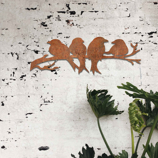 Metal garden decoration featuring four birds sitting on a branch, crafted with intricate cutout details and a rustic finish, adding a delightful and natural charm to outdoor walls or garden spaces.