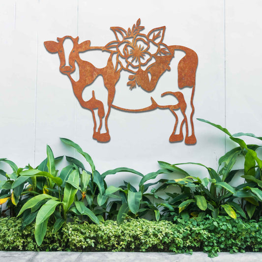 The artwork showcases a cow adorned with a detailed floral design on its back. The cow's form is outlined in a minimalist style, with the intricate flowers contrasting against its simple body, adding a decorative and natural element to the piece. 