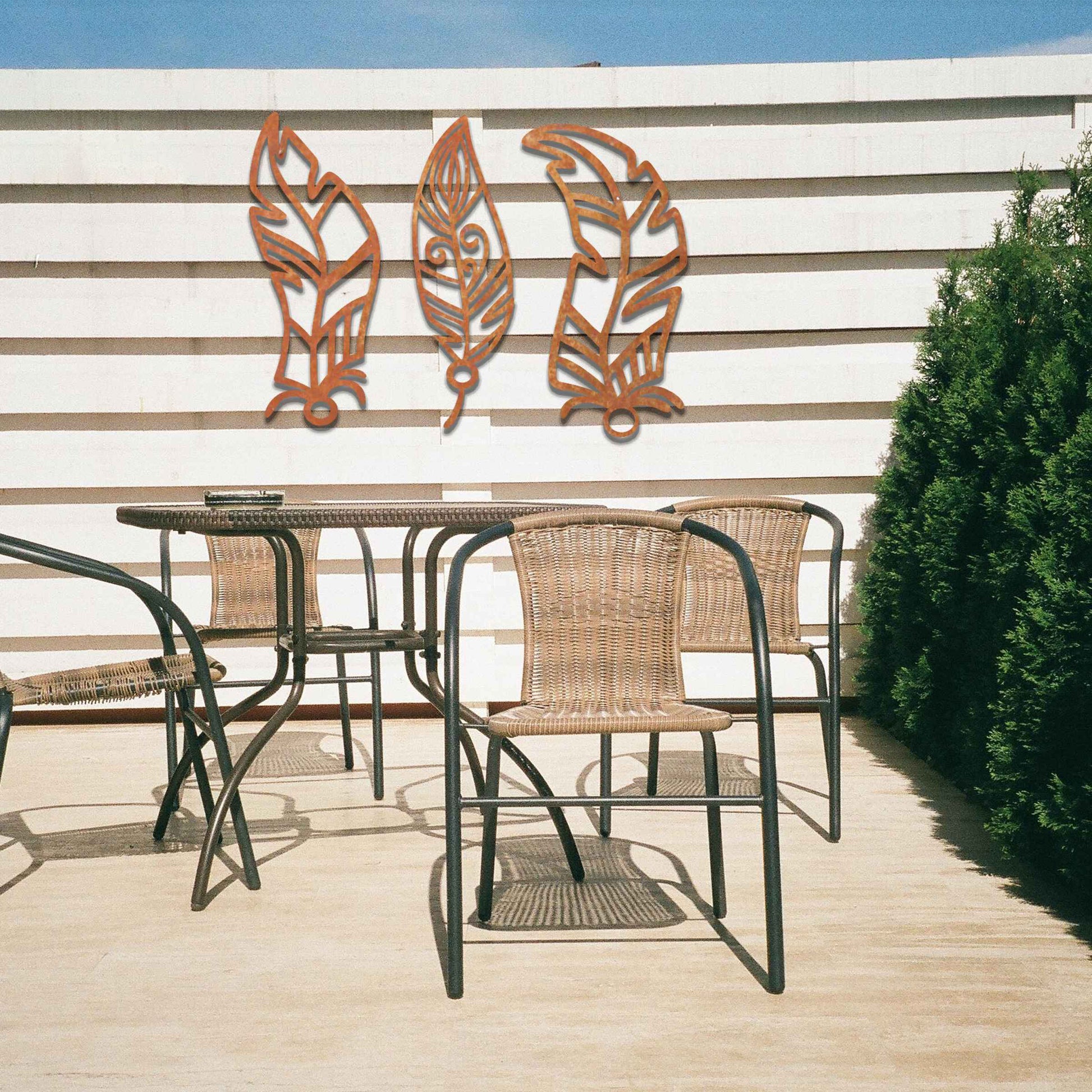 This design features three elegantly styled feathers, each with intricate patterns. The flowing lines and curved shapes give a sense of movement, making the artwork a beautiful representation of nature's delicate beauty.