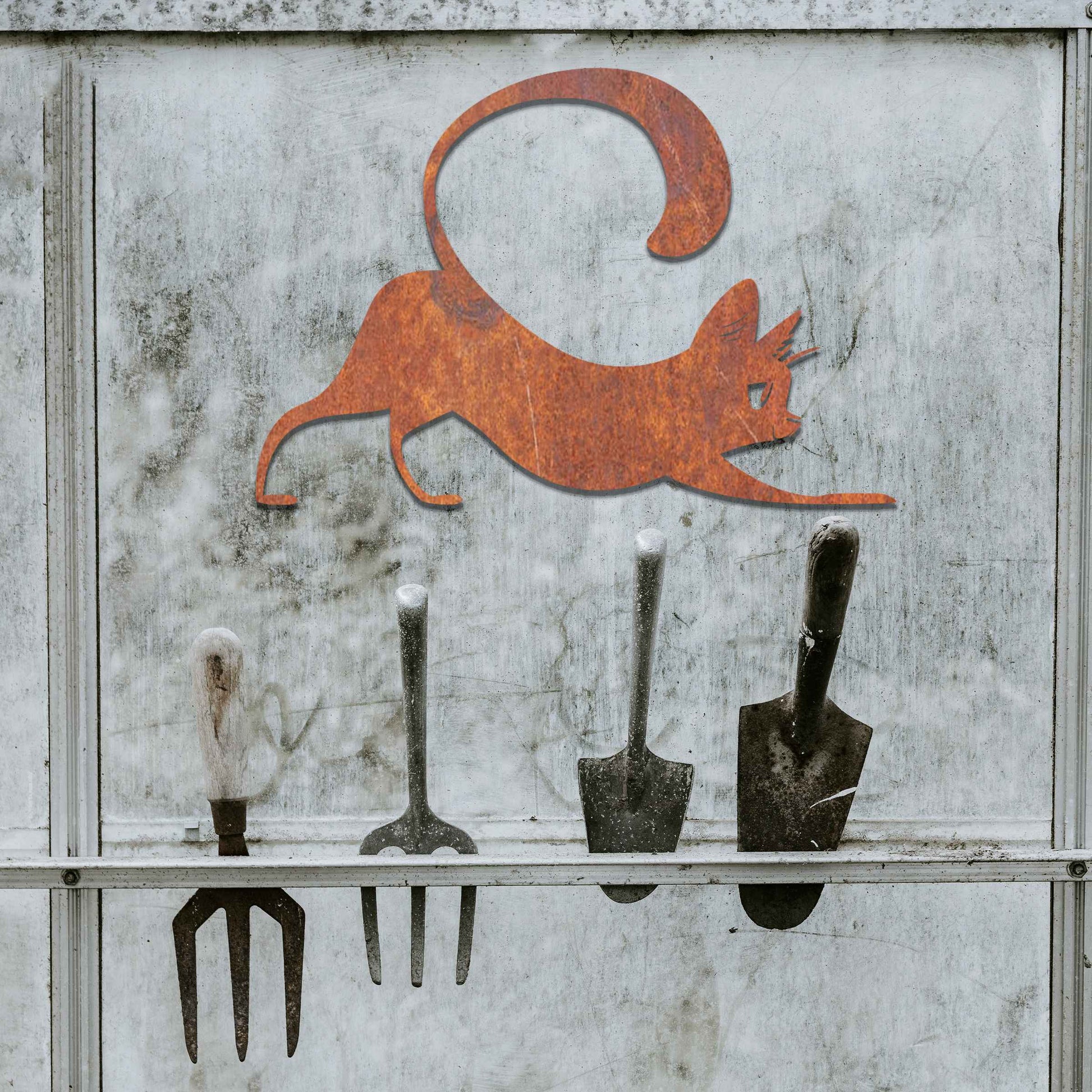 Metal garden decoration featuring a playful cat stretching with its tail curved upwards, crafted with sleek and elegant detailing, adding a touch of charm and liveliness to outdoor walls, fences, or doors.