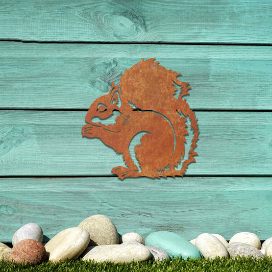 Metal garden decoration featuring a squirrel design with intricate cutout details, adding a whimsical and rustic charm to outdoor walls, blending seamlessly with natural garden surroundings.