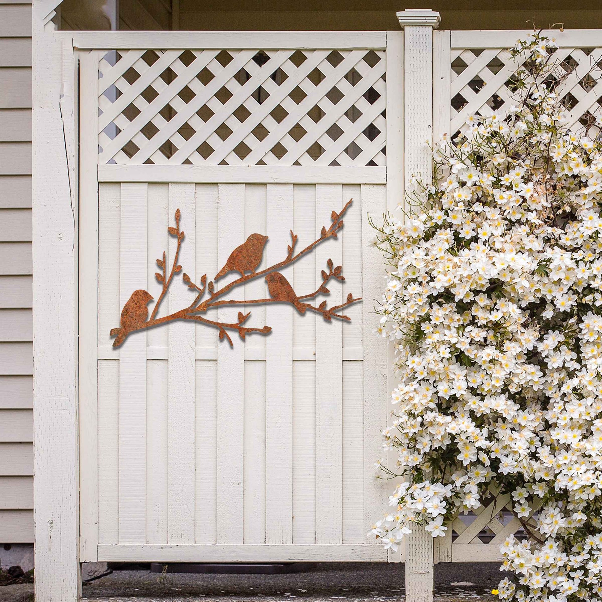 Metal garden decoration featuring three birds perched on a leafy branch, crafted with intricate cutout details and a rustic finish, adding a charming and natural touch to outdoor walls or garden spaces.
