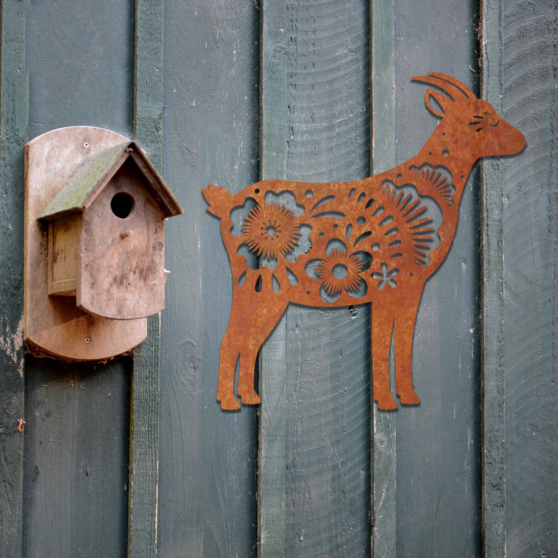 Side profile of a goat, beautifully adorned with intricate floral patterns along its body. The floral design enhances the natural grace of the animal, creating a charming and rustic piece of wall art.