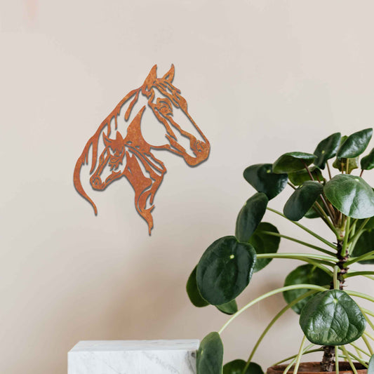 This metal wall art features two horse heads, one adult and one young, with elegant details showcasing their flowing manes and strong expressions. The design captures the connection and power of these majestic creatures.