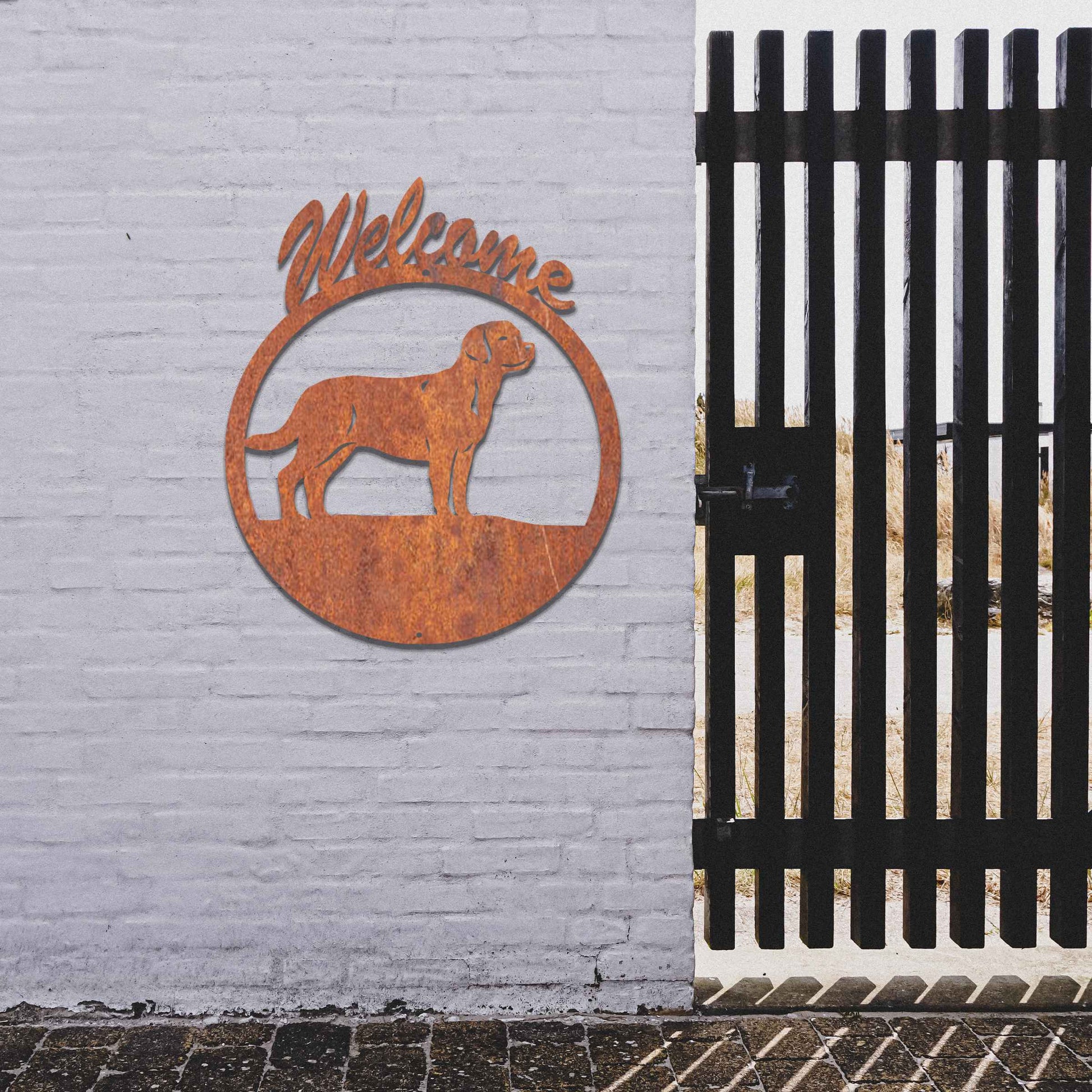 Metal garden art design showcasing a dog silhouette in profile, enclosed within a circular frame. Above the dog, the word Welcome is displayed, creating a warm and inviting atmosphere.