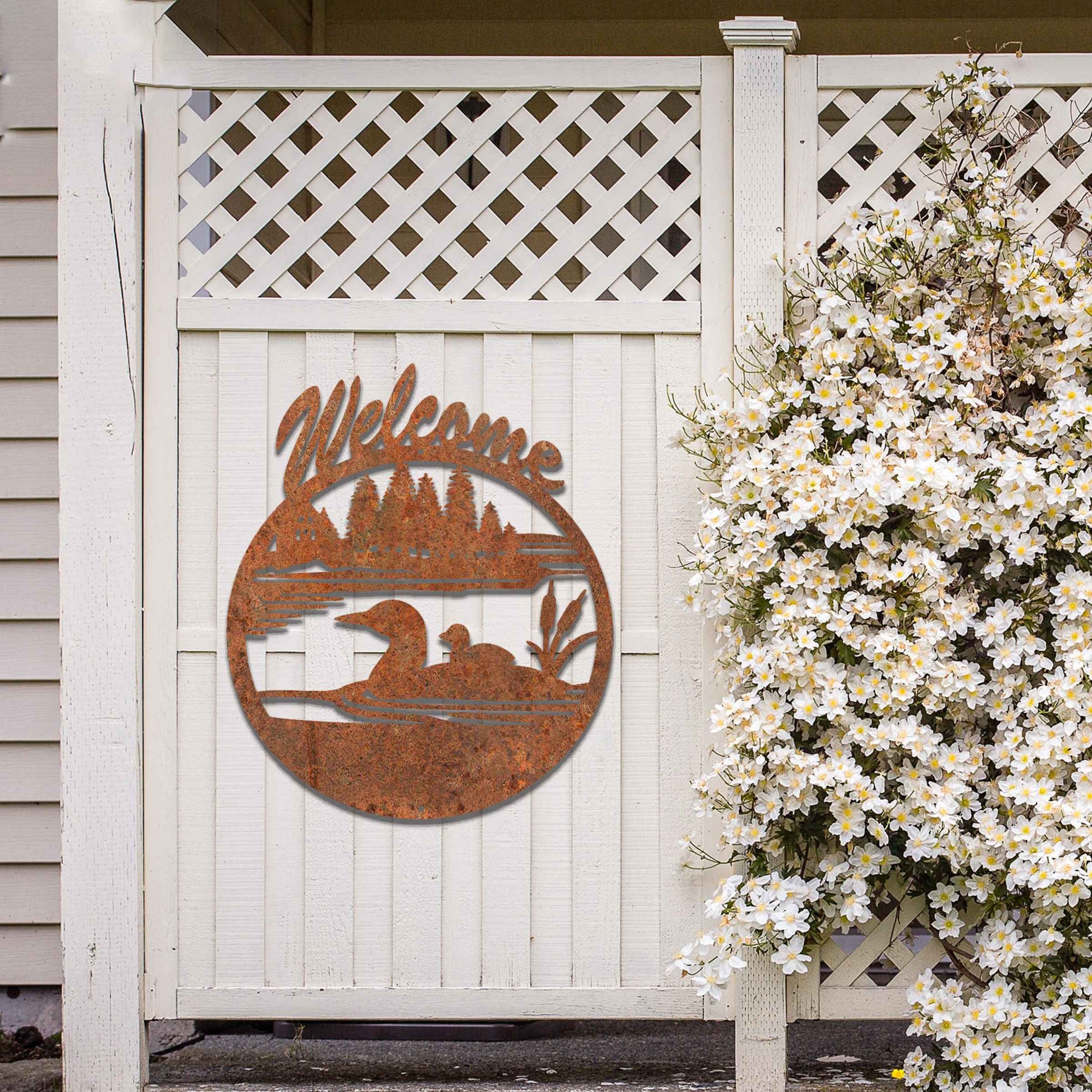 This design features two ducks in a water setting with the word "Welcome" above. The rustic finish adds charm, and the circular shape encapsulates the peaceful imagery, making it ideal for gardens or entrances.