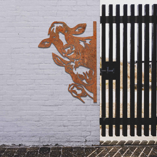 Metal decoration featuring a cow, a donkey, and a goose peeking around a vertical edge, crafted with intricate cutout details and a rustic finish, adding a whimsical and rustic charm to outdoor or garden spaces.