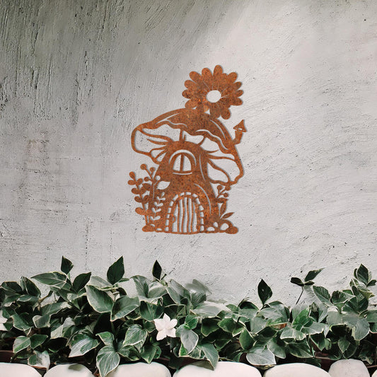 This piece depicts a whimsical mushroom house with a flower on top, surrounded by plants. Its enchanting design, perfect for garden or indoor decor, adds charm to any space with its delightful details.