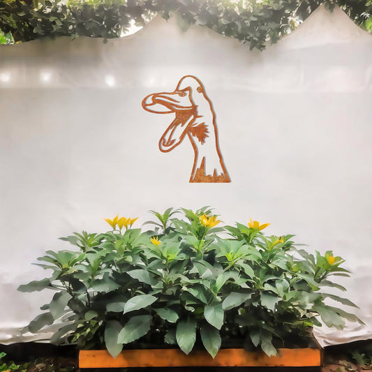A quirky metal wall art of a duck with an open beak, showcasing playful and artistic detail. This unique design adds a touch of humor and charm to any modern setting, surrounded by greenery and soft floral accents.