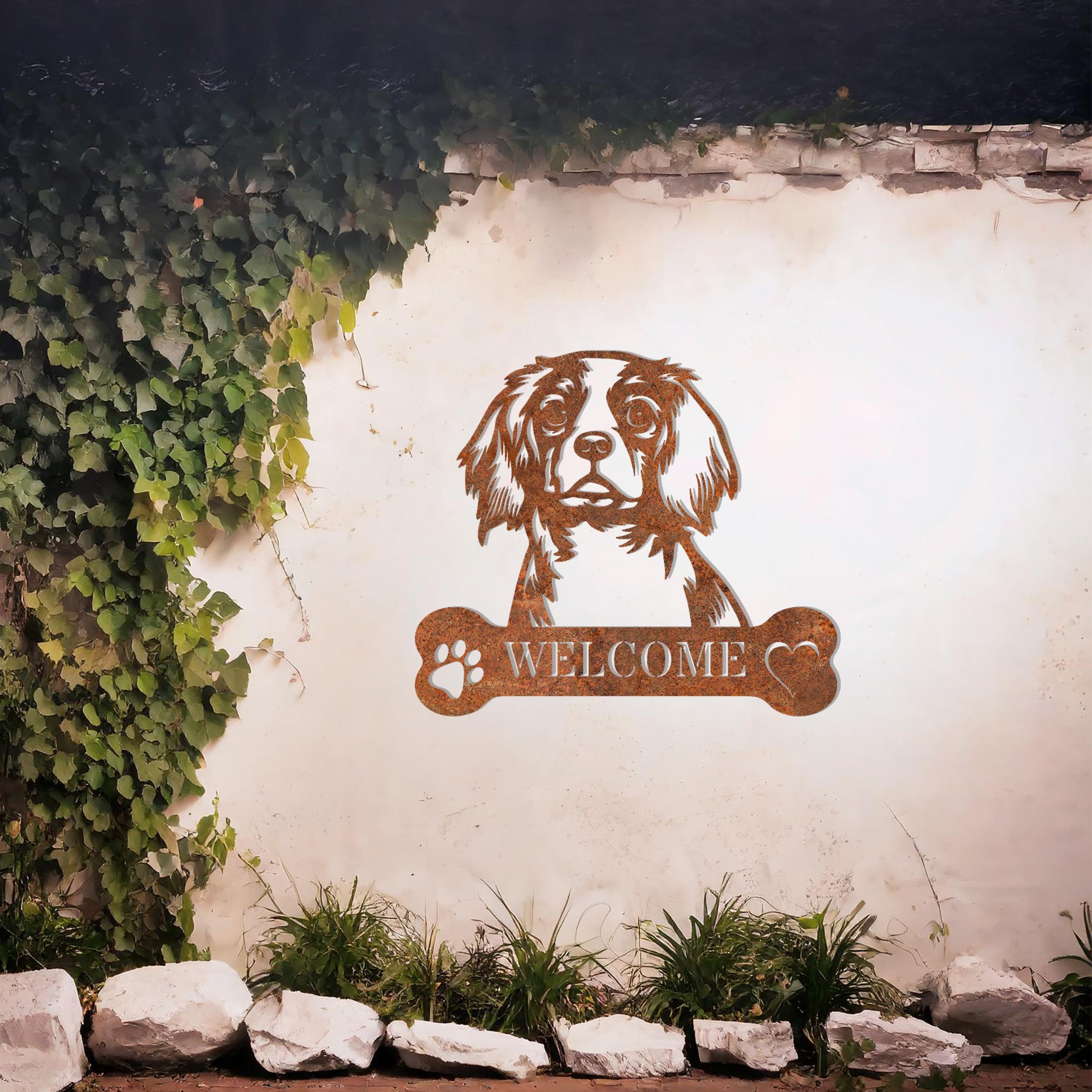 Metal Cavalier King Charles Spaniel dog design with a bone-shaped 'WELCOME' text and paw prints, perfect for adding a charming and welcoming touch to entryways or outdoor spaces.
