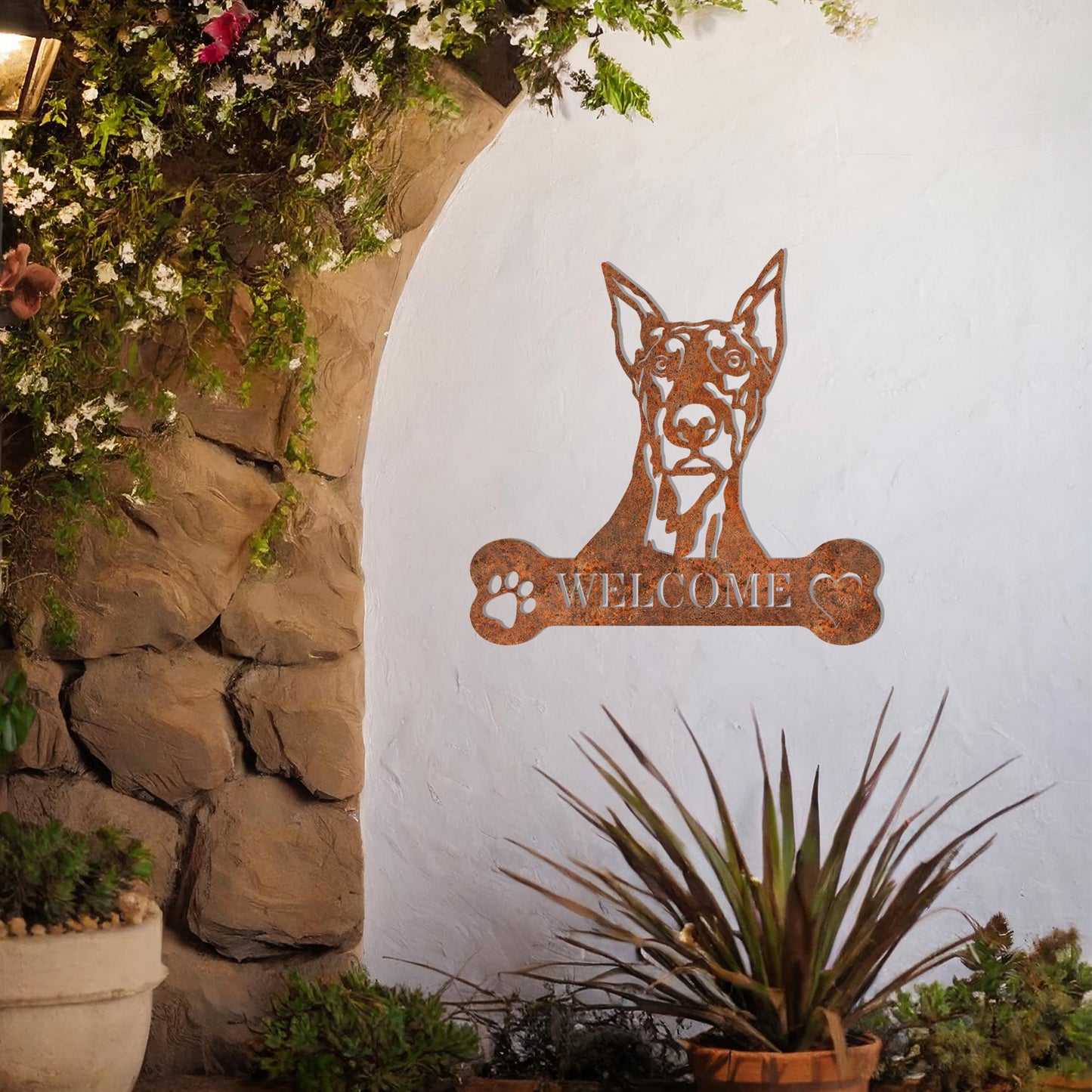 Metal Doberman dog design with a bone-shaped 'WELCOME' text and paw prints, perfect for adding a strong and welcoming touch to entryways or outdoor spaces.