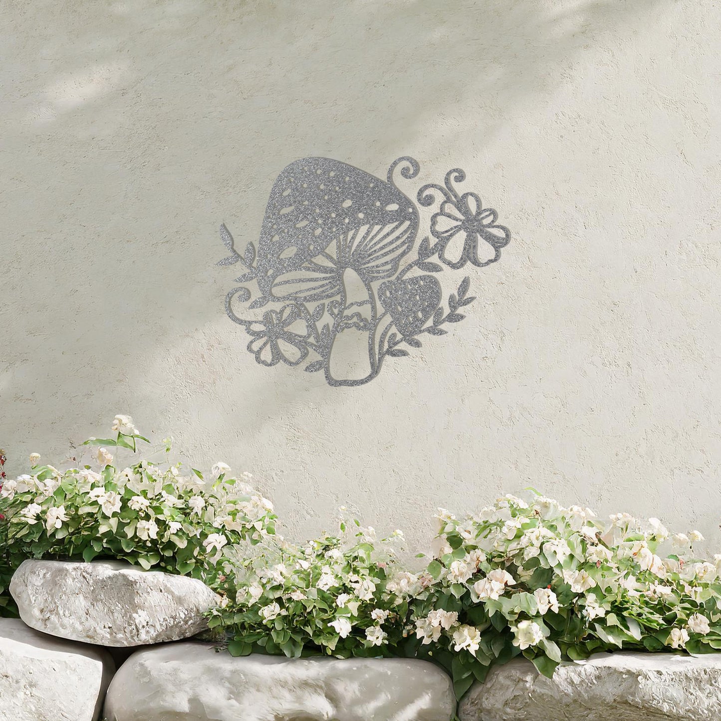 Metal garden decoration featuring a whimsical mushroom design surrounded by floral and leafy accents, intricately crafted to bring a touch of nature-inspired charm and artistry to outdoor spaces