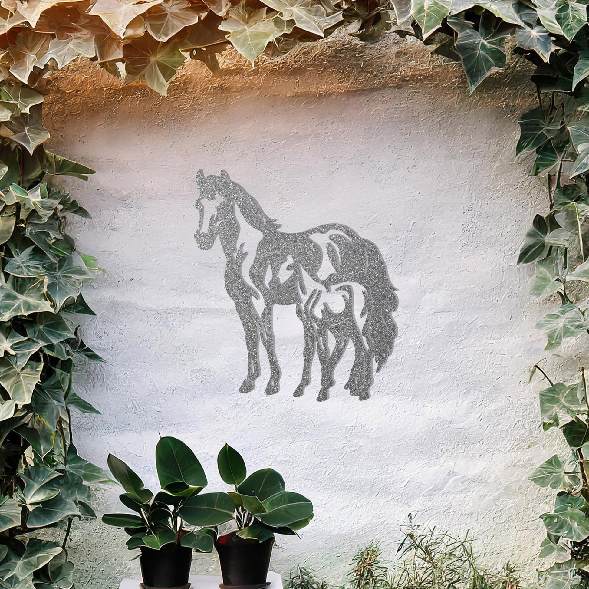 A stunning metal wall art design featuring two horses, showcasing a larger horse and a smaller one standing together, symbolising grace and unity. This artwork adds an elegant touch to a neutral wall in a beautifully styled outdoor space.