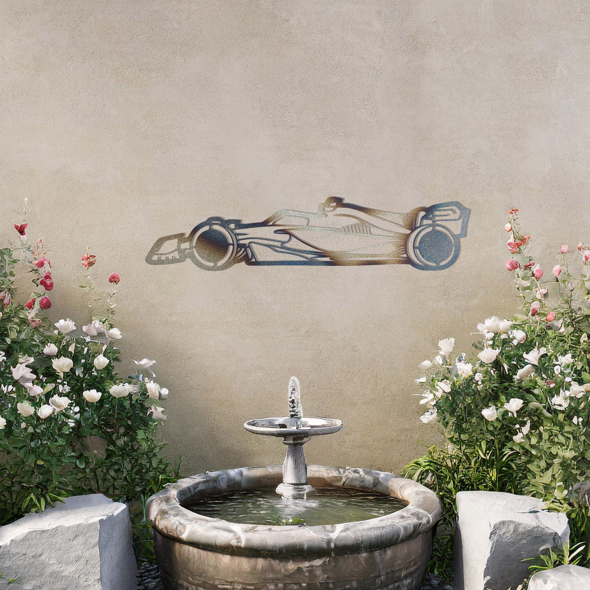 A sleek metal wall art design showcasing a detailed Formula 1 car silhouette. Perfect for motorsport enthusiasts, this artwork brings dynamic energy to modern or contemporary spaces. It is displayed on a neutral wall in a stylish outdoor setting.