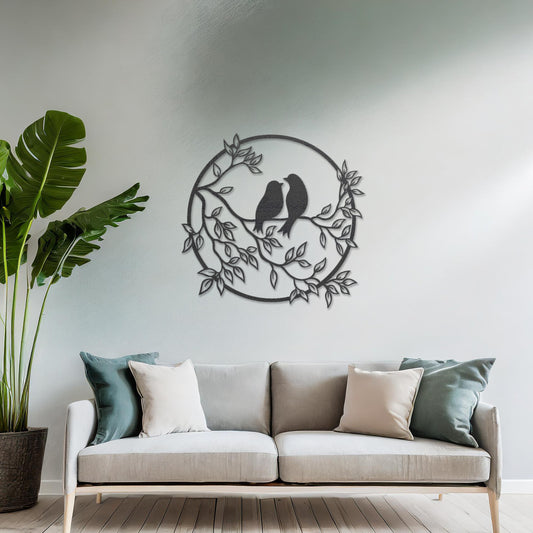 Wooden wall art featuring a circular design with two birds perched on a branch surrounded by leaves, displayed on a neutral wall within modern room decor, showcasing its delicate and nature-inspired craftsmanship.