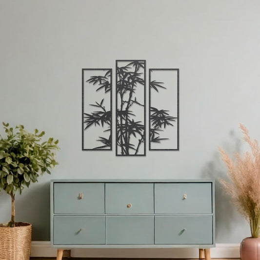 Wooden wall art consisting of three panels featuring a bamboo design with detailed leaves and stalks, displayed on a neutral wall within modern room decor, highlighting its elegant and nature-inspired craftsmanship.
