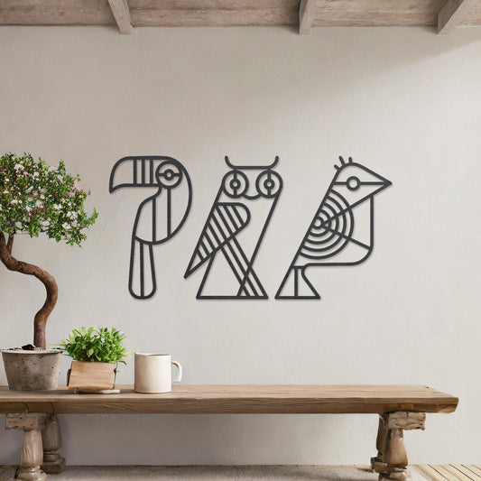 Wooden wall art featuring a trio of abstract geometric bird designs, including a toucan, an owl, and a sparrow. The artwork is displayed on a neutral wall within modern room decor, showcasing its playful and artistic charm.