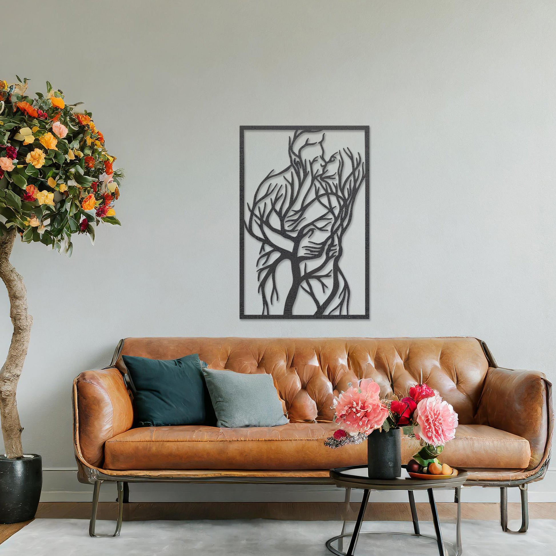 Wooden wall art featuring a rectangular design of two intertwined human figures stylised with tree branches, symbolising connection and unity. The artwork is displayed on a neutral wall within modern room decor, highlighting its artistic and emotional depth.