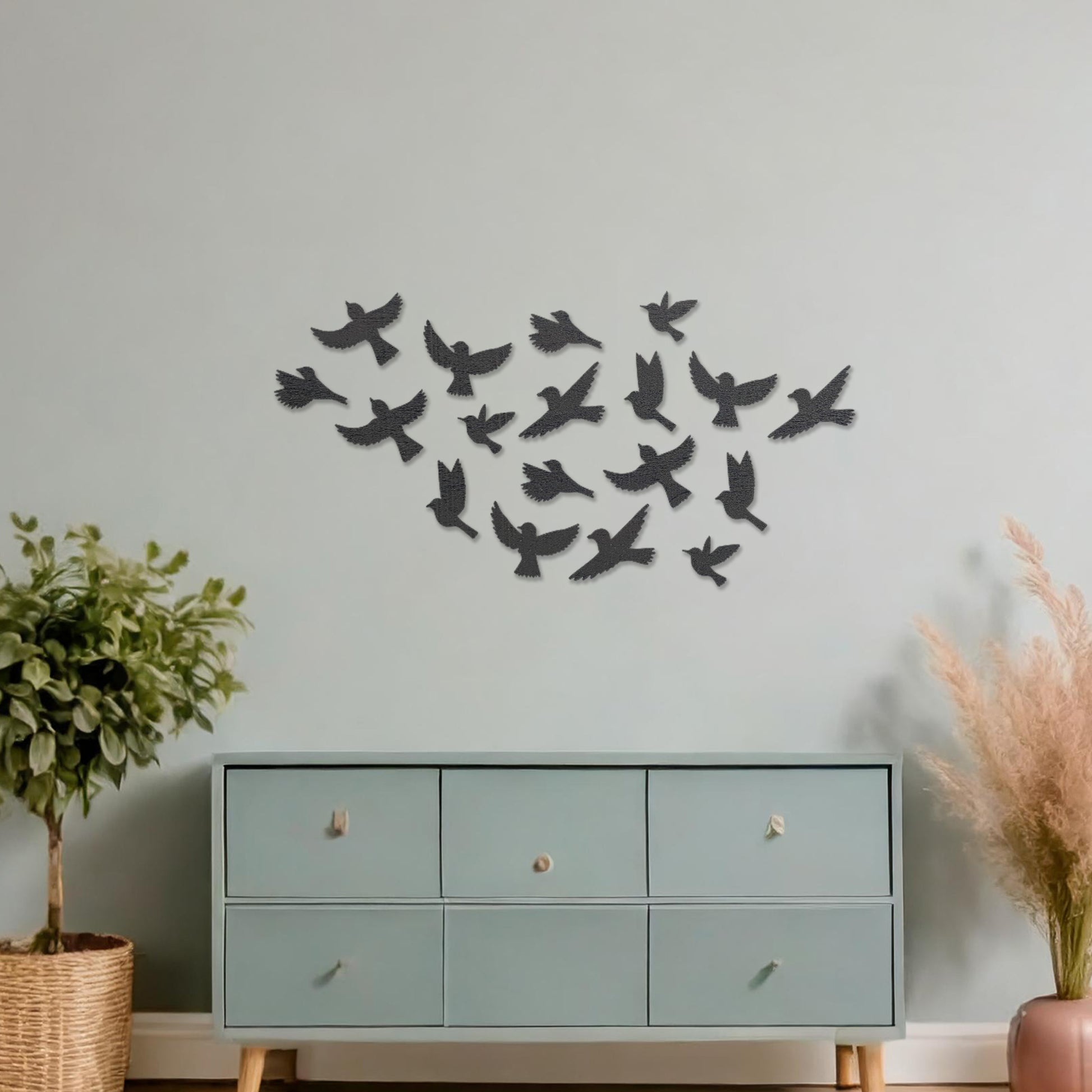 Wooden wall art featuring a flock of birds in flight arranged in a scattered pattern, displayed on a neutral wall within modern room decor, highlighting its dynamic and nature-inspired craftsmanship.