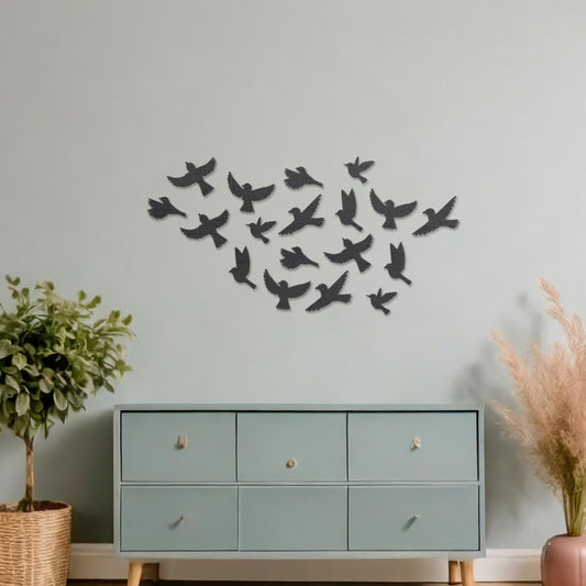 Wooden wall art featuring a flock of birds in flight arranged in a scattered pattern, displayed on a neutral wall within modern room decor, highlighting its dynamic and nature-inspired craftsmanship.