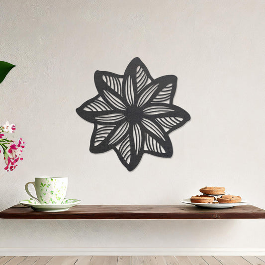 Wall art featuring a star-shaped floral design with layered petals and intricate cut-out patterns. The piece is displayed on a neutral wall within modern decor, adding a unique and decorative focal point to the space.
