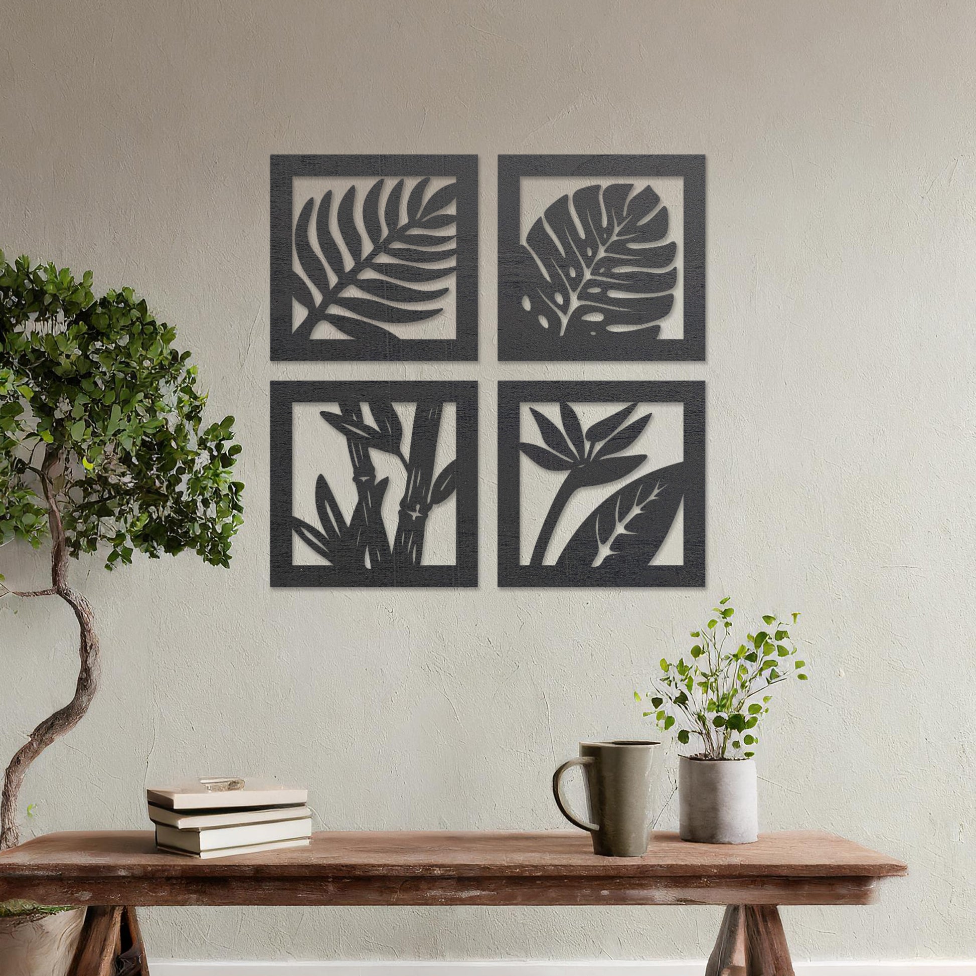 Wooden wall art design featuring four square panels with different plant leaf motifs, placed on a neutral wall within modern room decor. The design highlights nature's variety with intricate leaf patterns in a minimalist style.