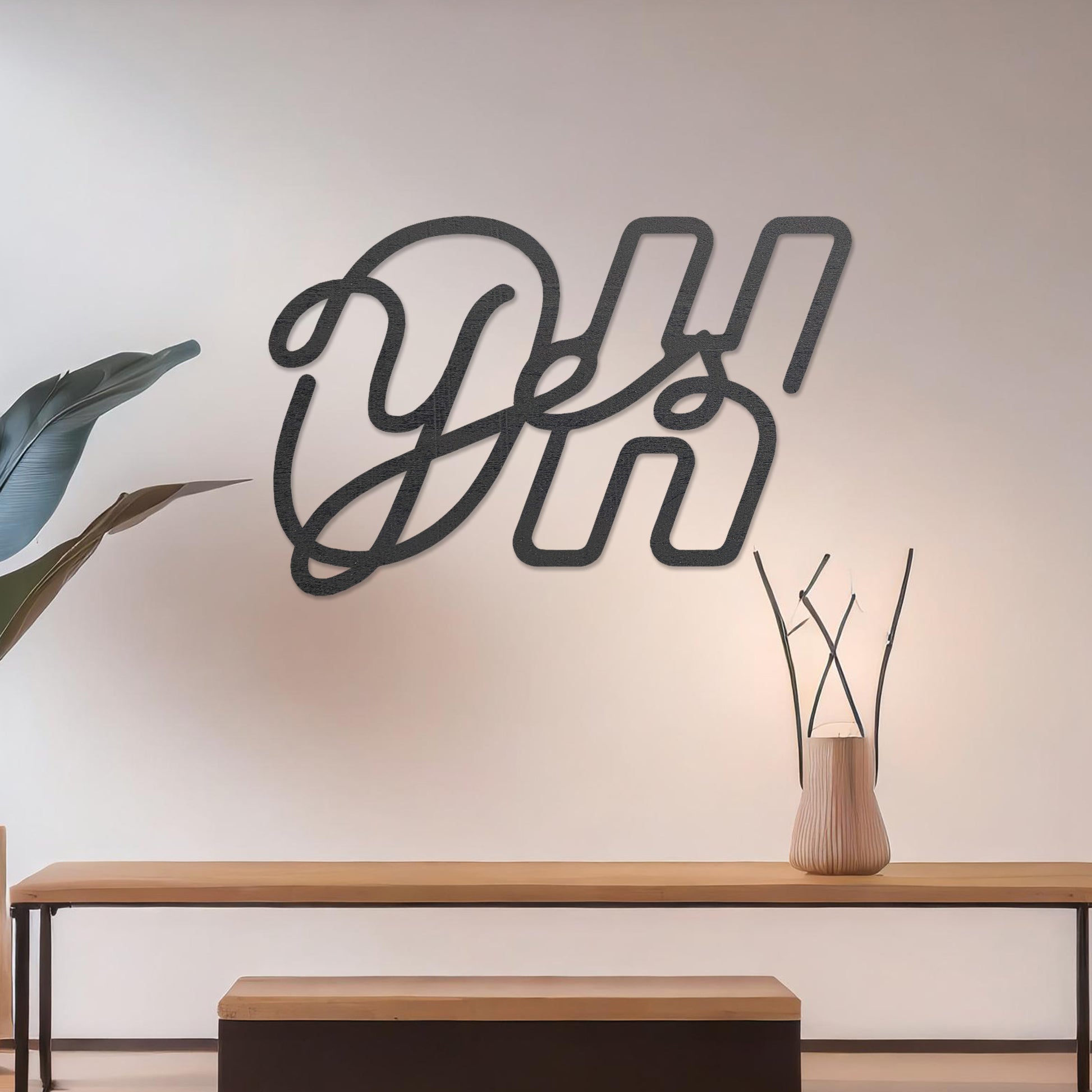 Wall art featuring the phrase "Oh Yes" in an elegant, flowing script combined with bold, block-style letters. The piece is displayed on a neutral wall within modern decor, adding a creative and playful touch to the space.
