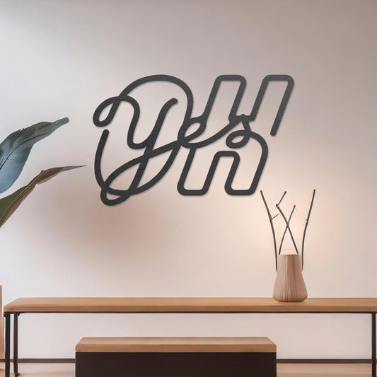 Wall art featuring the phrase "Oh Yes" in an elegant, flowing script combined with bold, block-style letters. The piece is displayed on a neutral wall within modern decor, adding a creative and playful touch to the space.