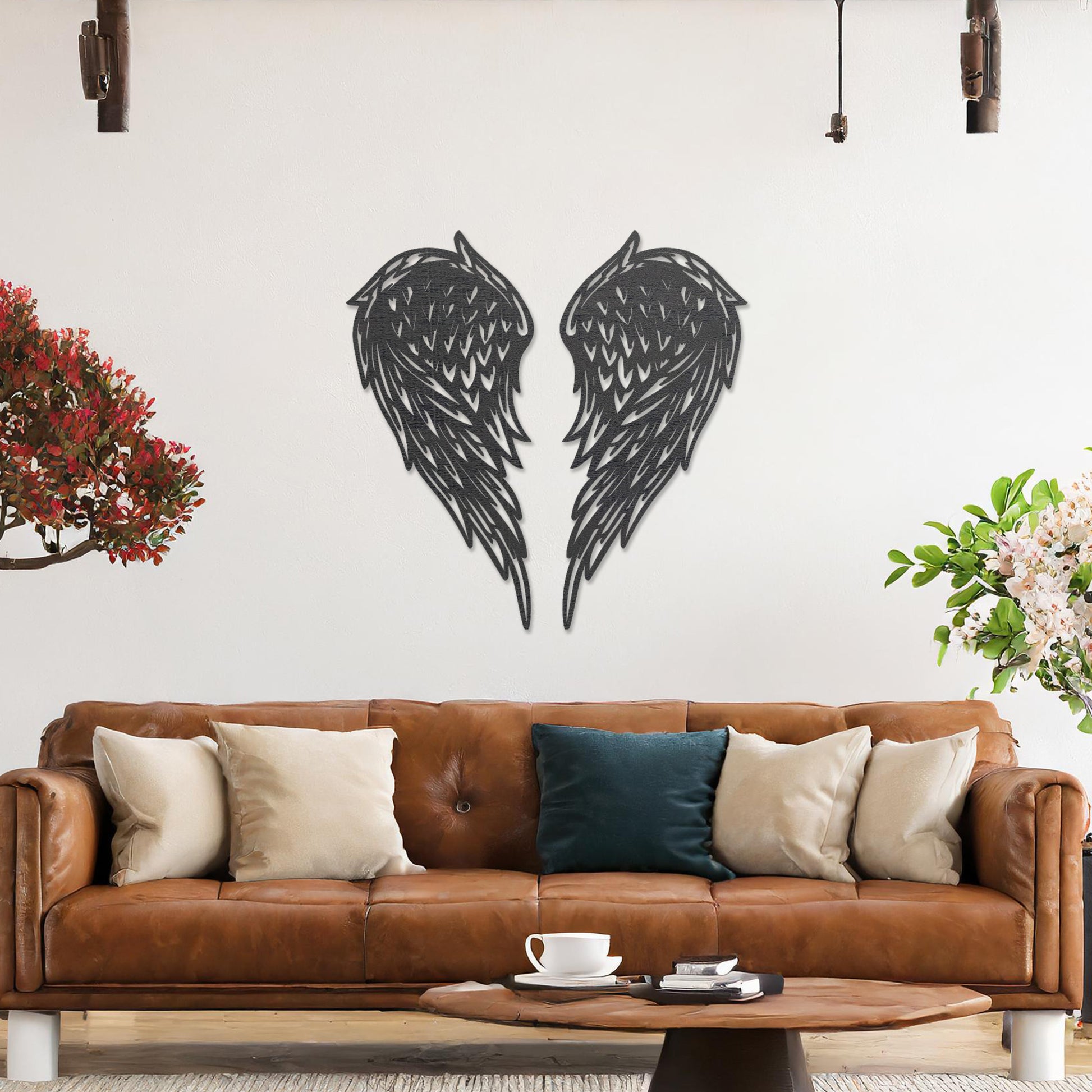 Wall art showcasing intricately designed angel wings with detailed feather patterns, displayed on a neutral wall in a modern living room. The piece adds a sense of elegance and serenity to the contemporary decor.