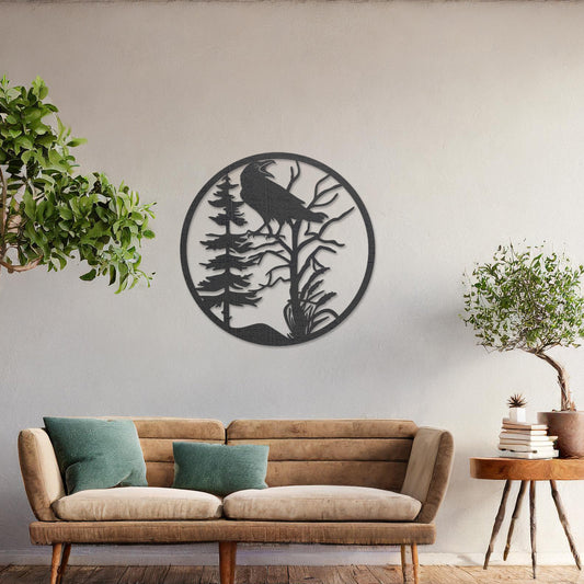 Wooden wall art featuring a circular design with a silhouette of a bird perched on a tree surrounded by natural elements. The artwork is displayed on a neutral wall within modern room decor, highlighting its rustic and nature-inspired design.