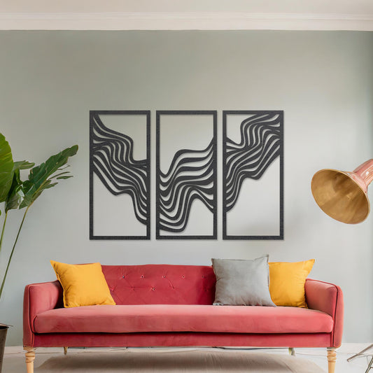 This image displays a modern triptych wall art design featuring flowing wave-like lines. The abstract patterns create a dynamic and visually appealing composition, adding an elegant touch to the living room's decor, complemented by a colourful sofa and floor lighting.