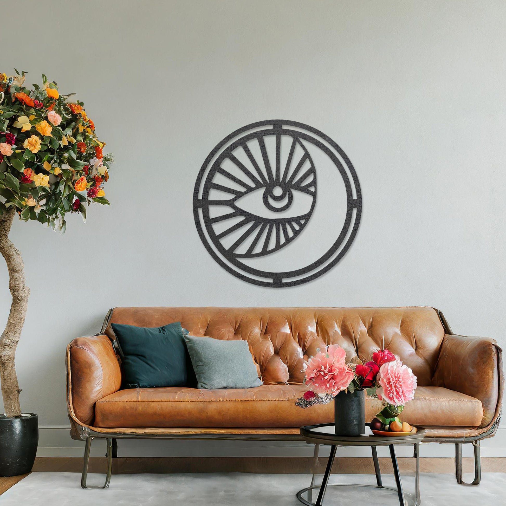 Wooden wall art featuring a circular design with an eye motif and geometric patterns radiating outward. The artwork is displayed on a neutral wall within modern room decor, highlighting its bold and contemporary aesthetic.