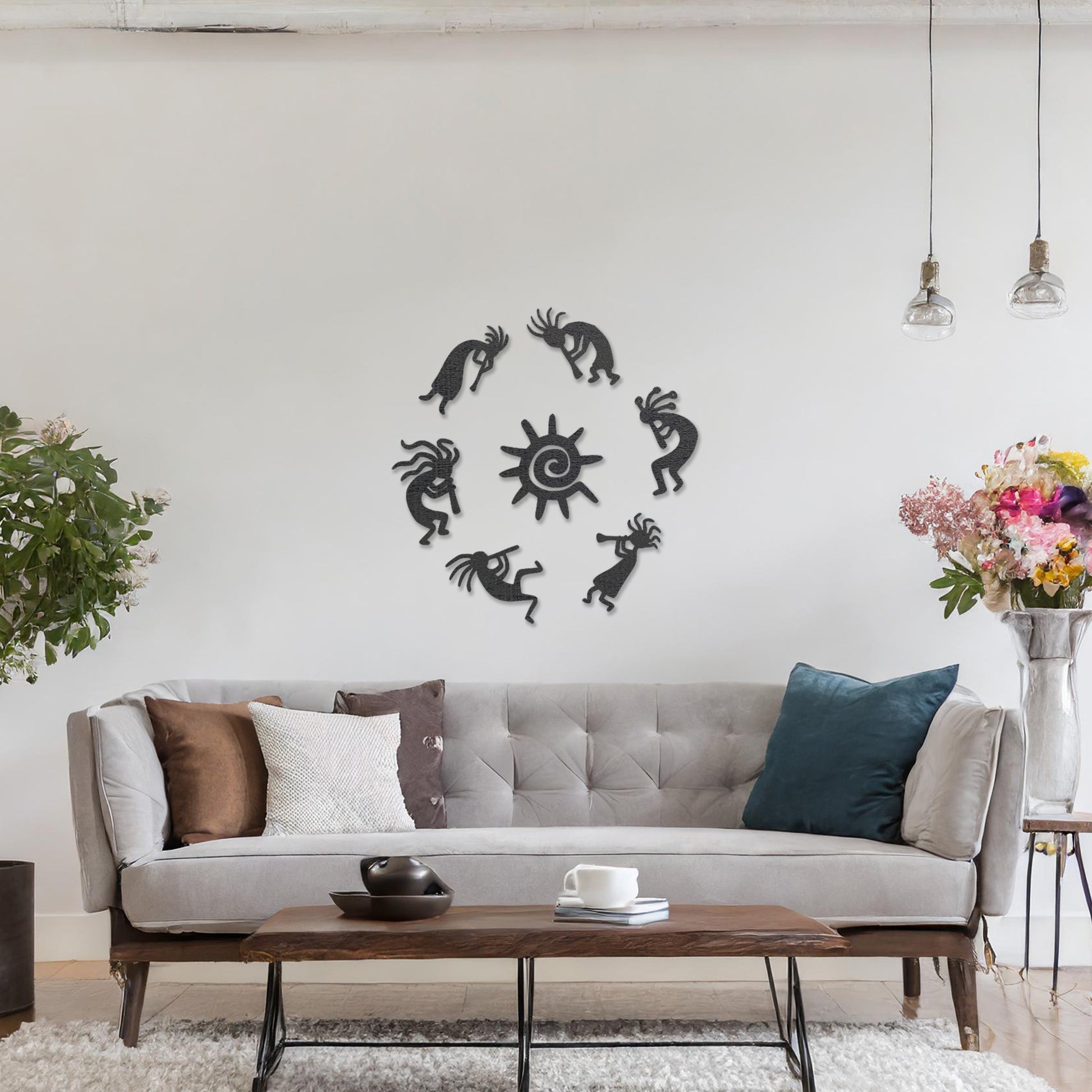 Wooden wall art featuring a circular arrangement of dancing figures surrounding a central sun design. The artwork is displayed on a neutral wall within modern room decor, highlighting its tribal and artistic charm.