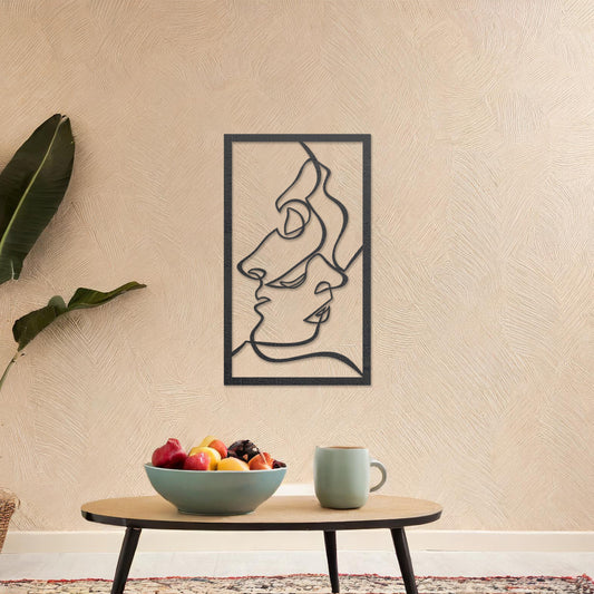 Wooden wall art design featuring abstract line art of two faces, placed on a neutral wall with modern room decor. The design is minimalistic and elegant, capturing human forms through flowing lines.