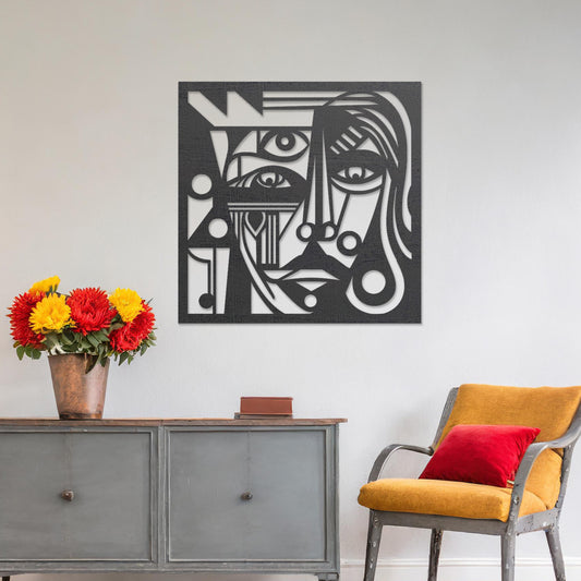 Wall art featuring an abstract face design with intricate geometric patterns and bold linework. The piece is displayed on a neutral wall within modern decor, adding a striking and artistic focal point to the space.